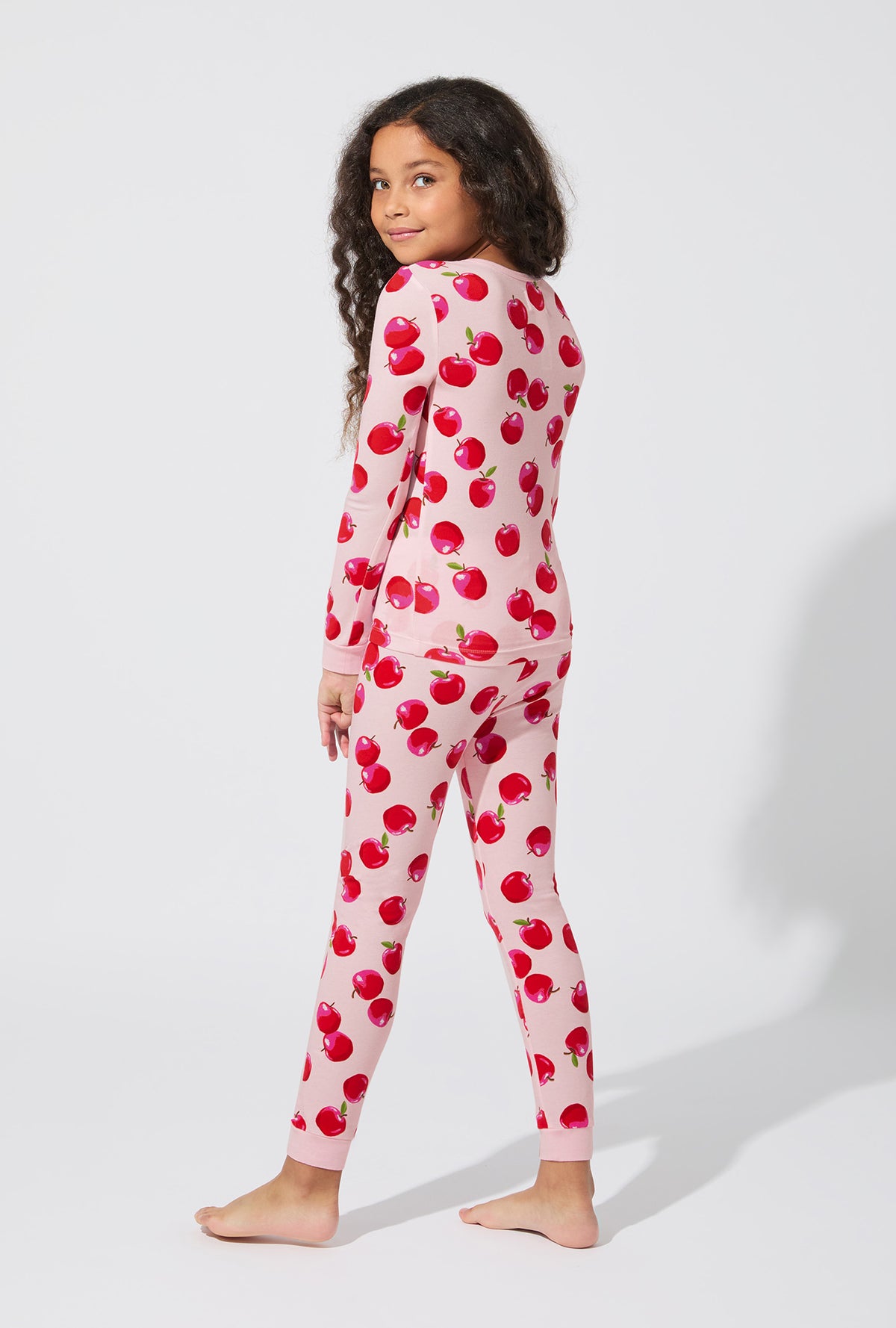 A girl wearing An Apple A Day Long Sleeve Stretch Jersey Kids PJ Set