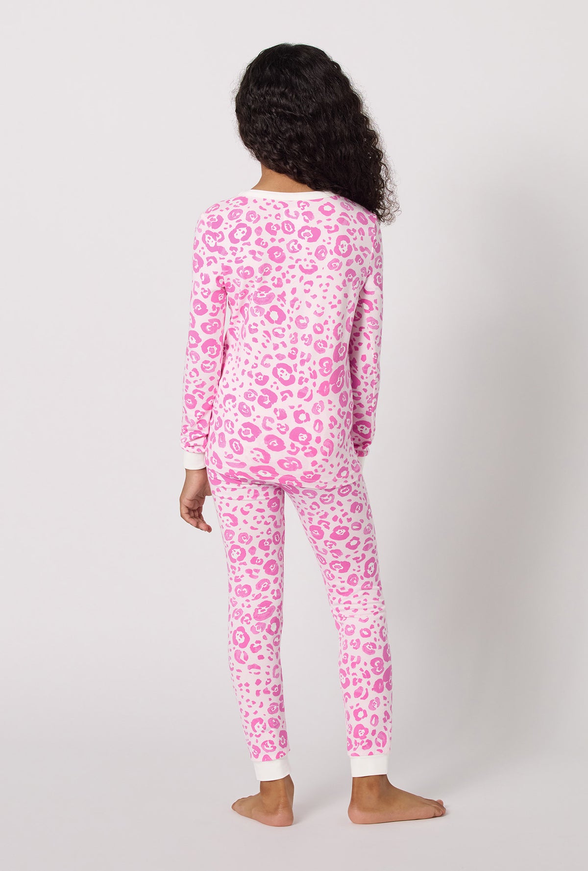 A Girl Wearing Valentina Leopard Long Sleeve Stretch Jersey Kids Pj Set in a back view pose