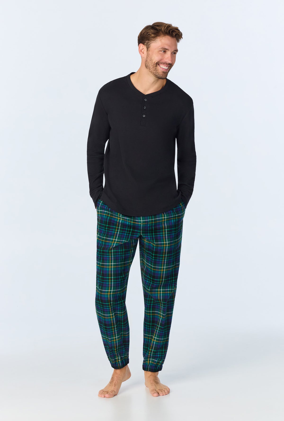 A man wearing Celebration Plaid Men&#39;s Long Sleeve Henley and Jogger Woven Portuguese Flannel  PJ Set