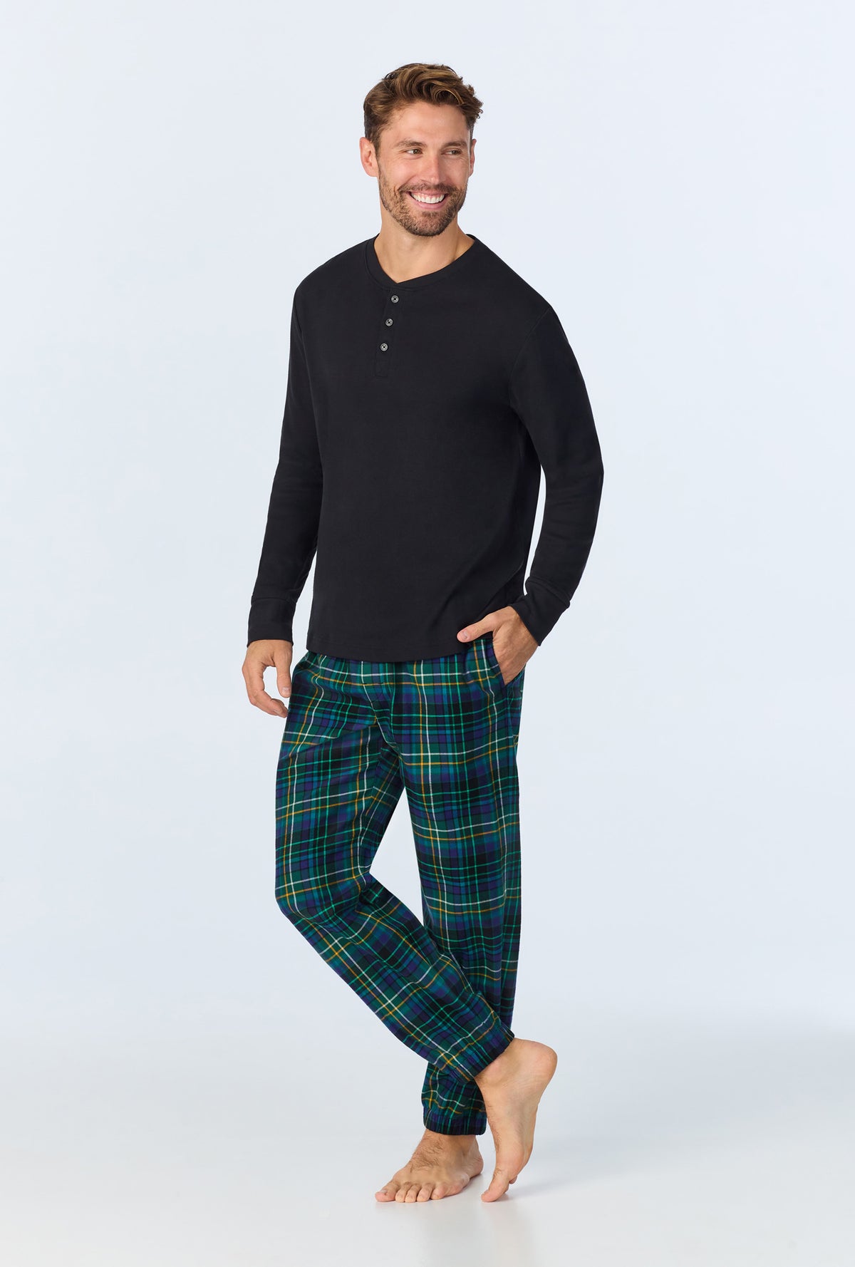 A man wearing Celebration Plaid Men&#39;s Long Sleeve Henley and Jogger Woven Portuguese Flannel  PJ Set