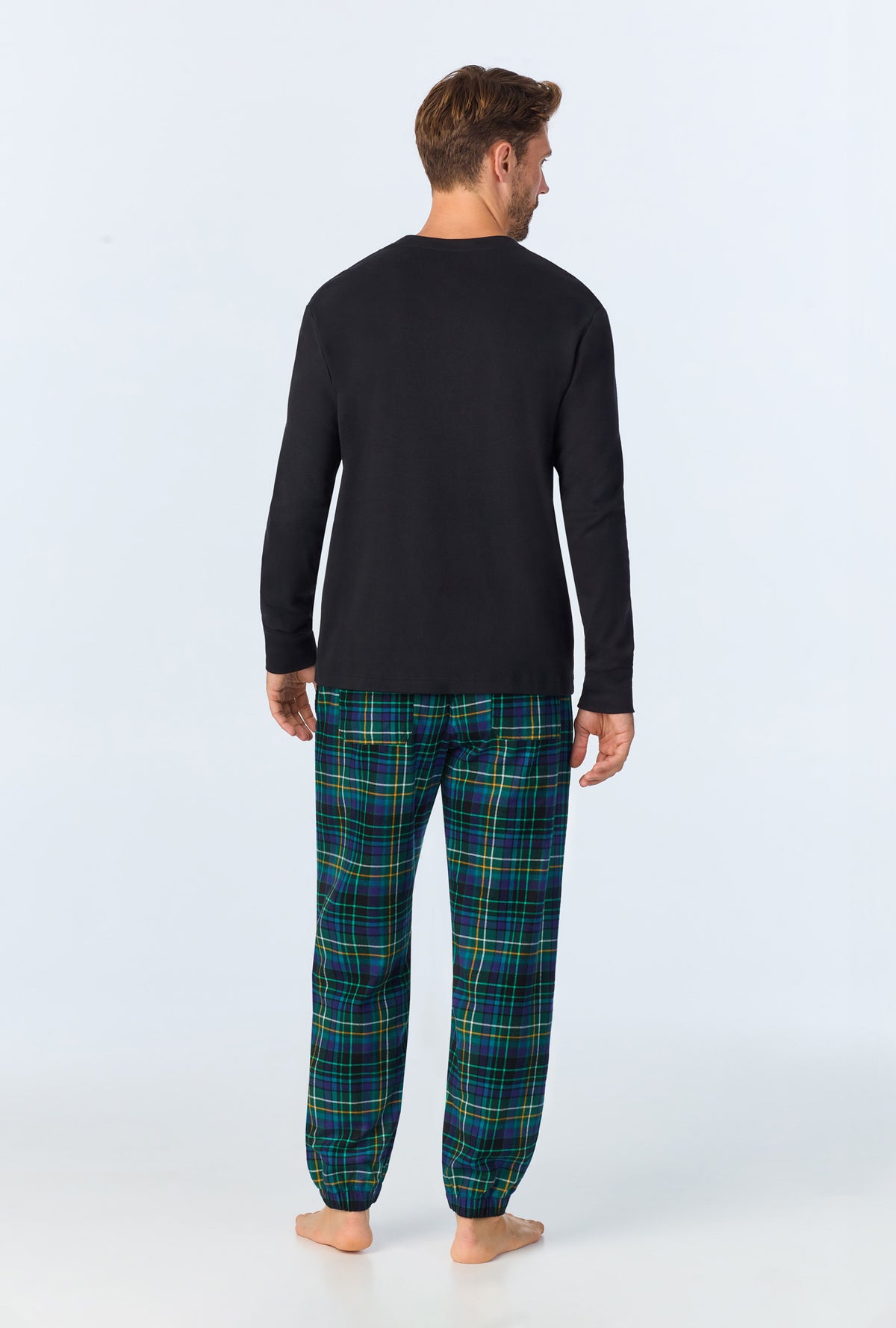 A man wearing Celebration Plaid Men&#39;s Long Sleeve Henley and Jogger Woven Portuguese Flannel  PJ Set