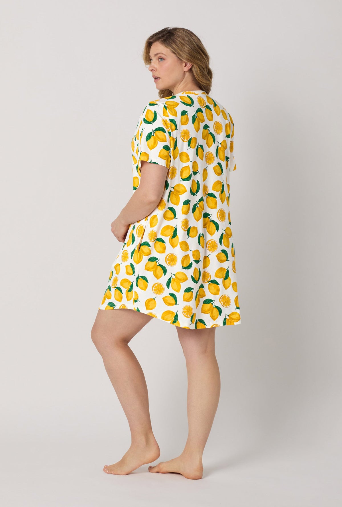 A lady wearing plus size White and  Yellow Stretch Jersey T-Shirt Sleep Dress back view