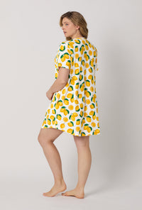 A lady wearing plus size White and  Yellow Stretch Jersey T-Shirt Sleep Dress back view