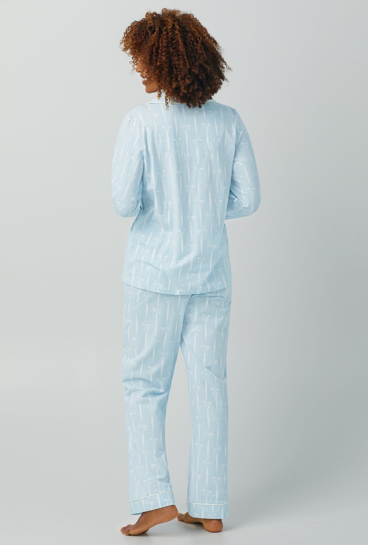 A lady wearing Long Sleeve Classic Stretch Jersey PJ Set with tying the knot print