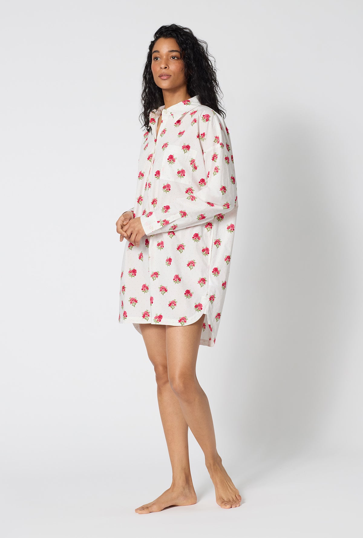 A Lady Wearing Celeste High Low Woven Supersoft Cotton Poplin Boyfriend Shirt facing front in a side angled pose
