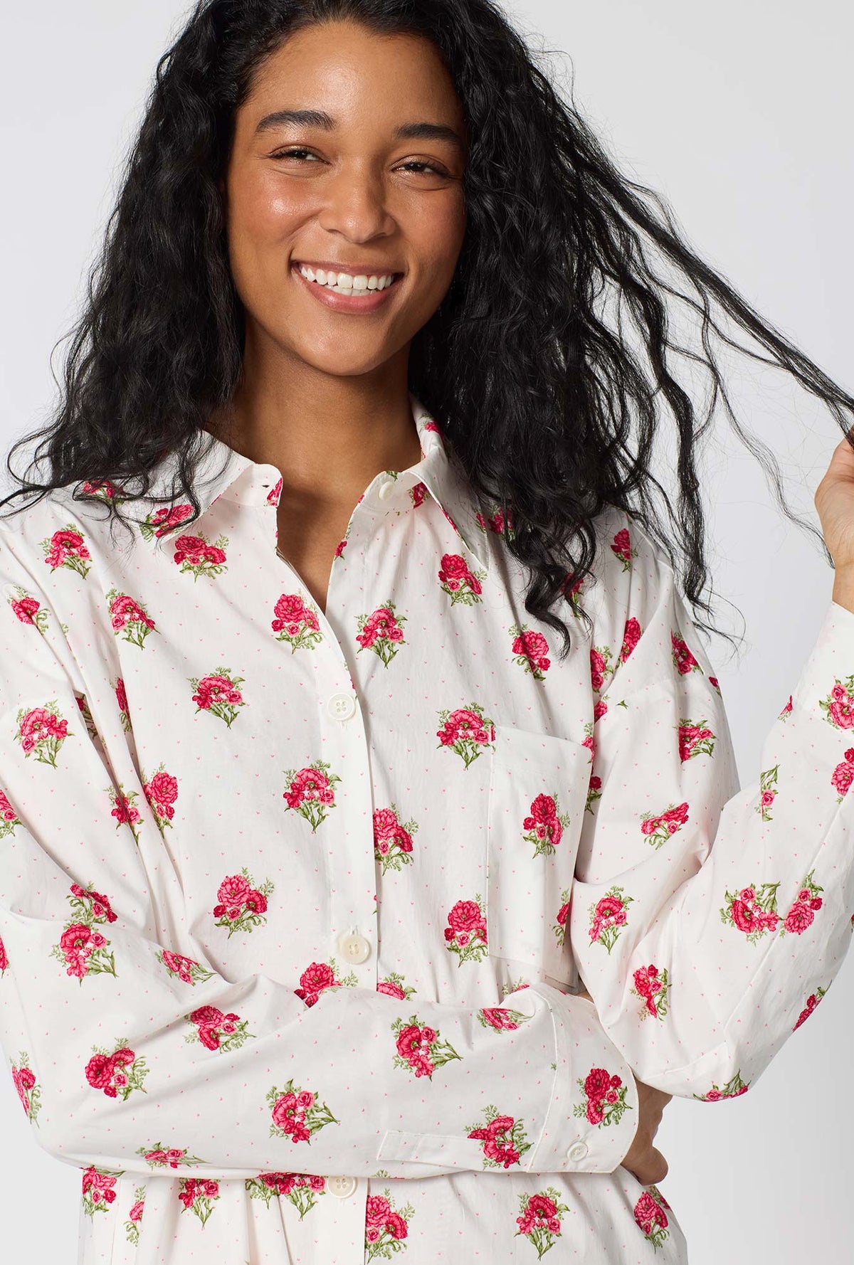 A Lady Wearing Celeste High Low Woven Supersoft Cotton Poplin Boyfriend Shirt facing front in a close up shot with a smile
