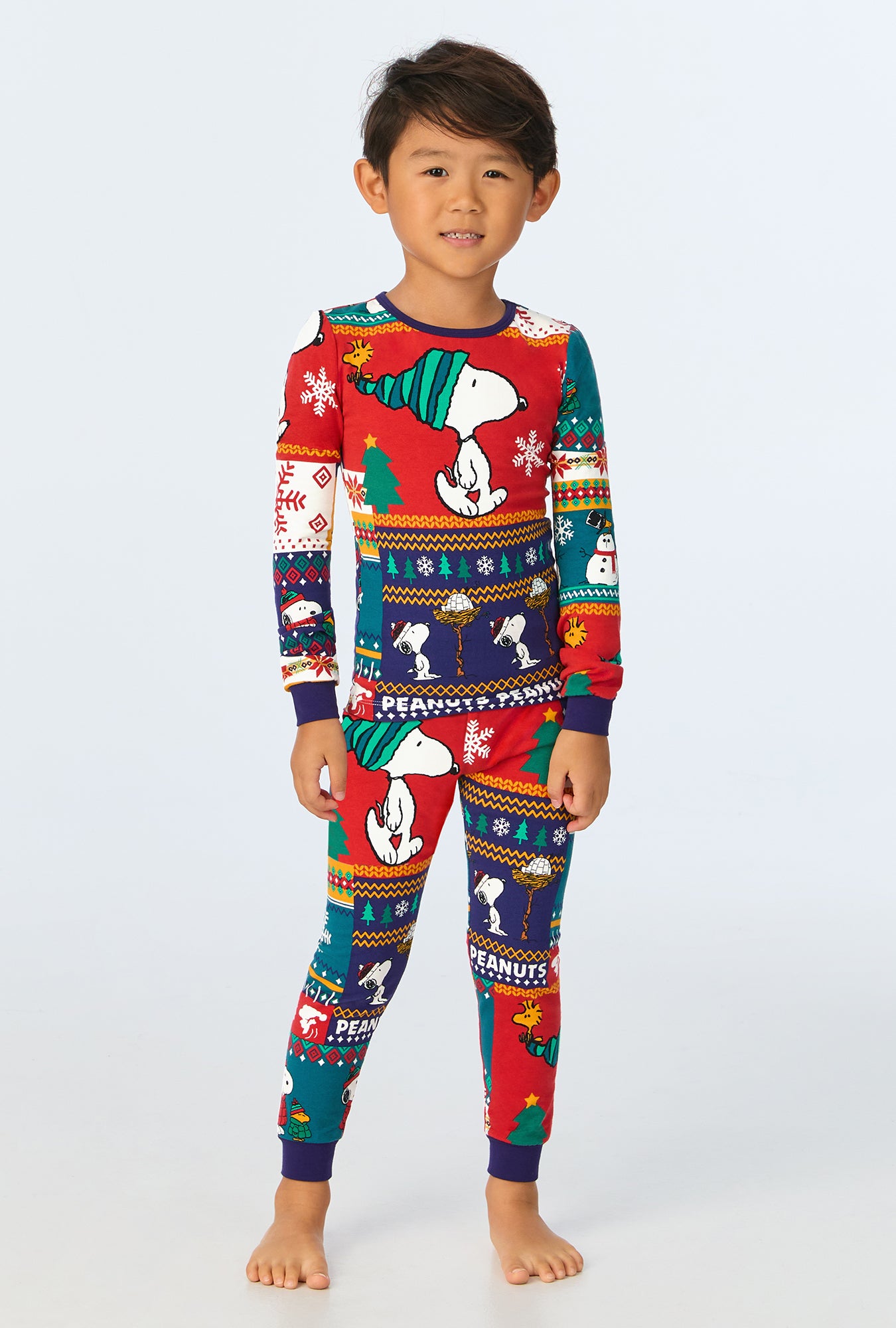 A child wearing Fairisle Snoopy® Long Sleeve Stretch Jersey Kids PJ Set