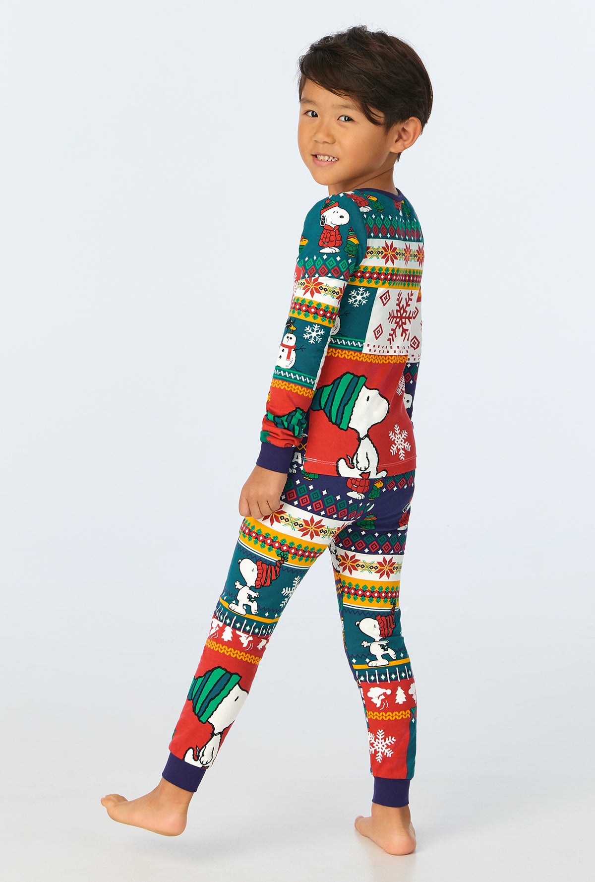 A child wearing Fairisle Snoopy® Long Sleeve Stretch Jersey Kids PJ Set