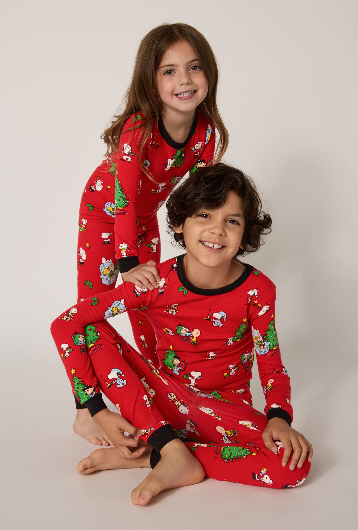 A boy and girl wearing Merry, Beagle, & Bright Long Sleeve Stretch Jersey Kids Pj Set