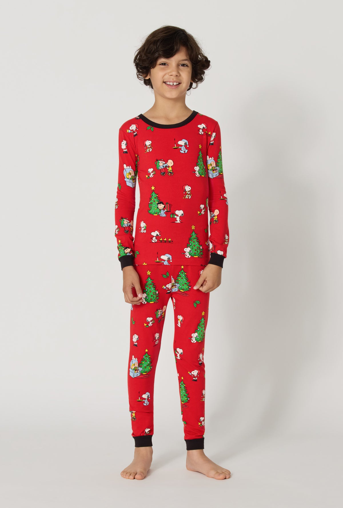 A boy wearing Merry, Beagle, & Bright Long Sleeve Stretch Jersey Kids Pj Set 