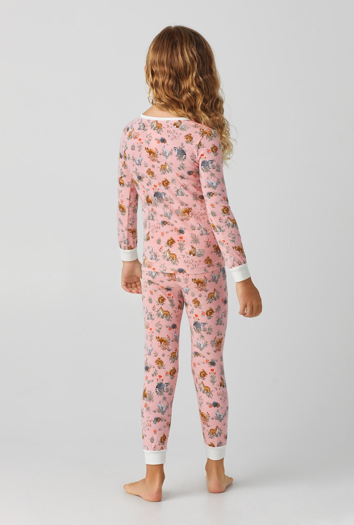 A girl wearing Forest Friends Long Sleeve Stretch Jersey Kids PJ Set