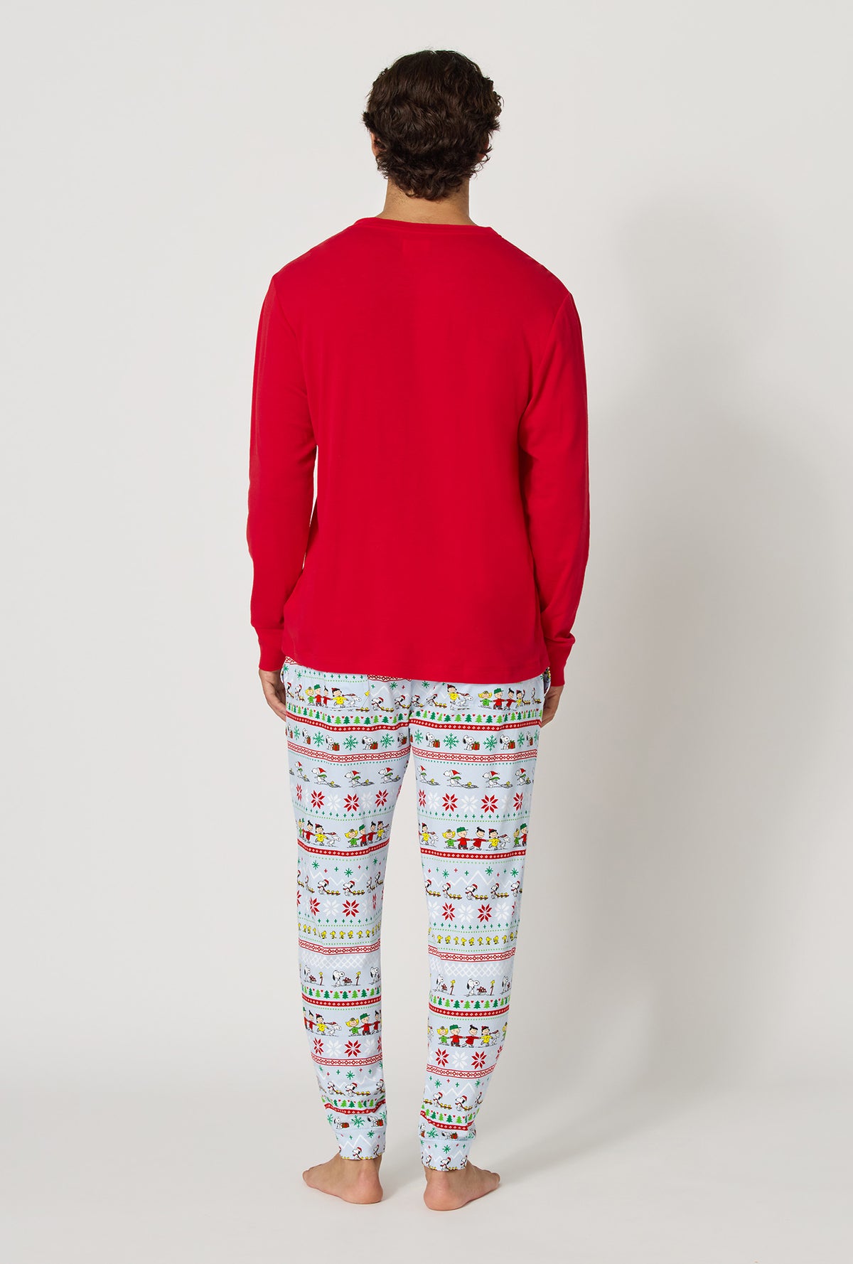 A man wearing Peanuts® Winter Parade Men's Long Sleeve Henley And Jogger Stretch Jersey Pj Set back view