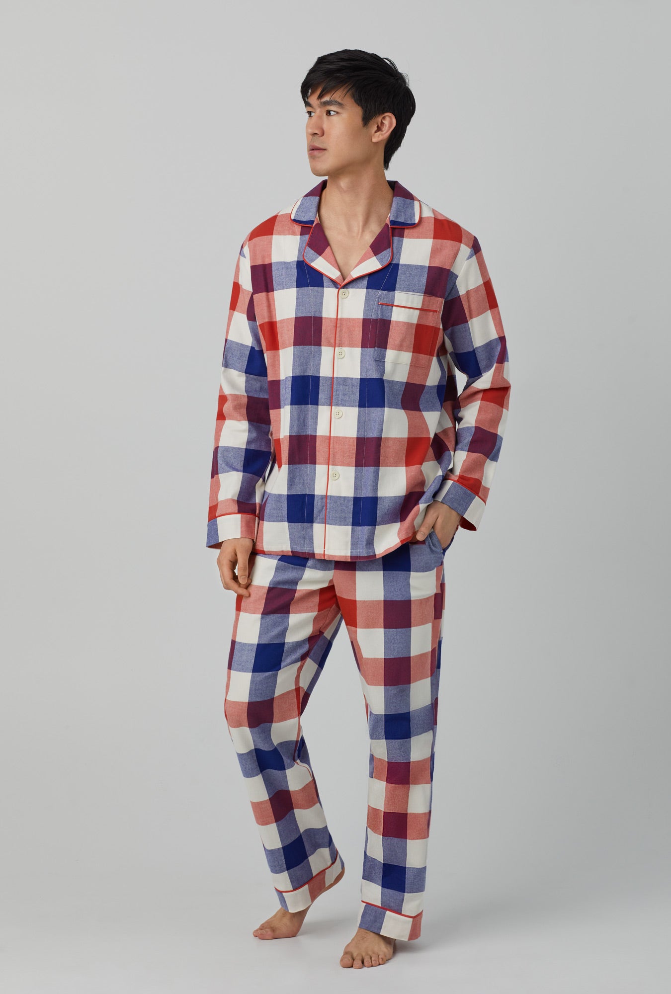 A man wearing men's long sleeve classic woven portugeese flannel twill pj set with harvest plaid print.