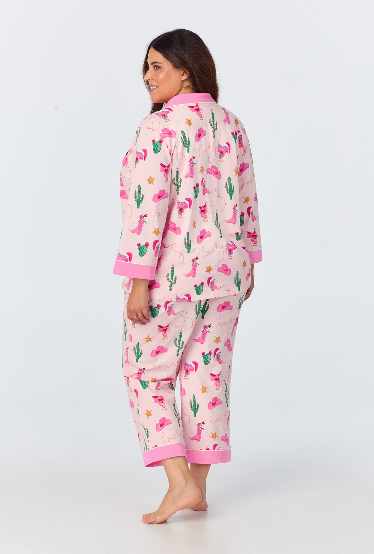A lady wearing Christmas Cowgirl 3/4 Sleeve Classic Stretch Jersey Cropped PJ Set
