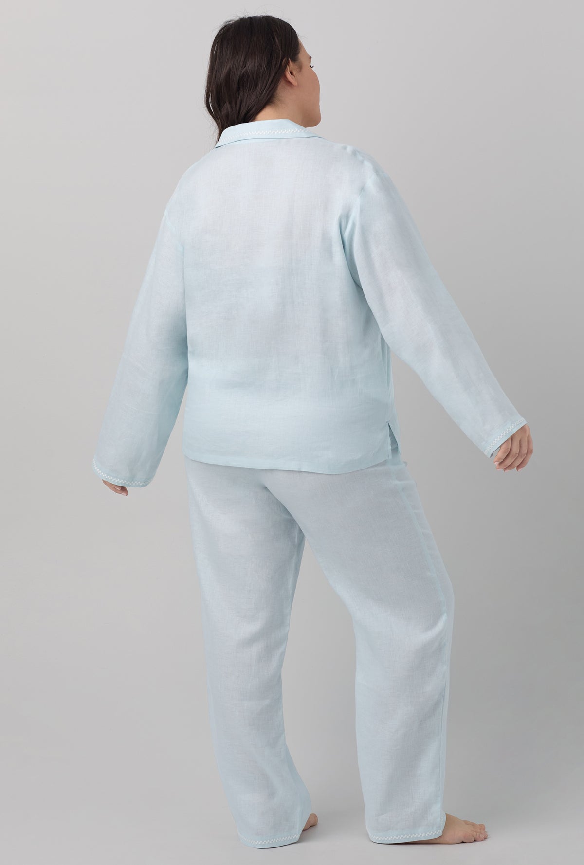 A lady wearing blue long sleeve classic linen plus size pj set with delicate blue print.