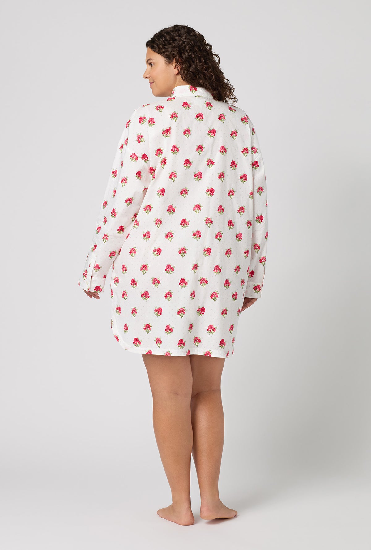 A Lady Wearing Plus Size Celeste High Low Woven Supersoft Cotton Poplin Boyfriend Shirt in a back view pose