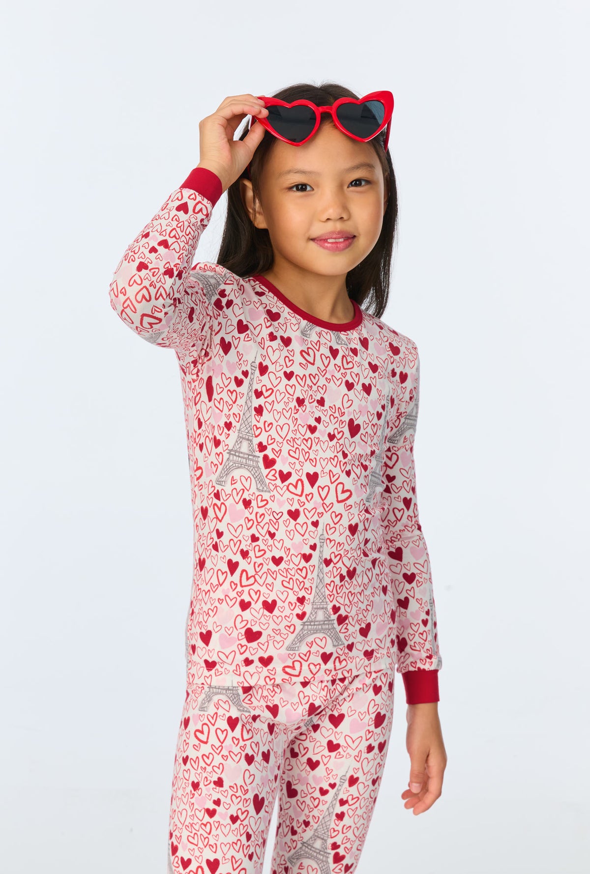 A girl wearing Paris Je Taime Long Sleeve Stretch Jersey Kids PJ Set