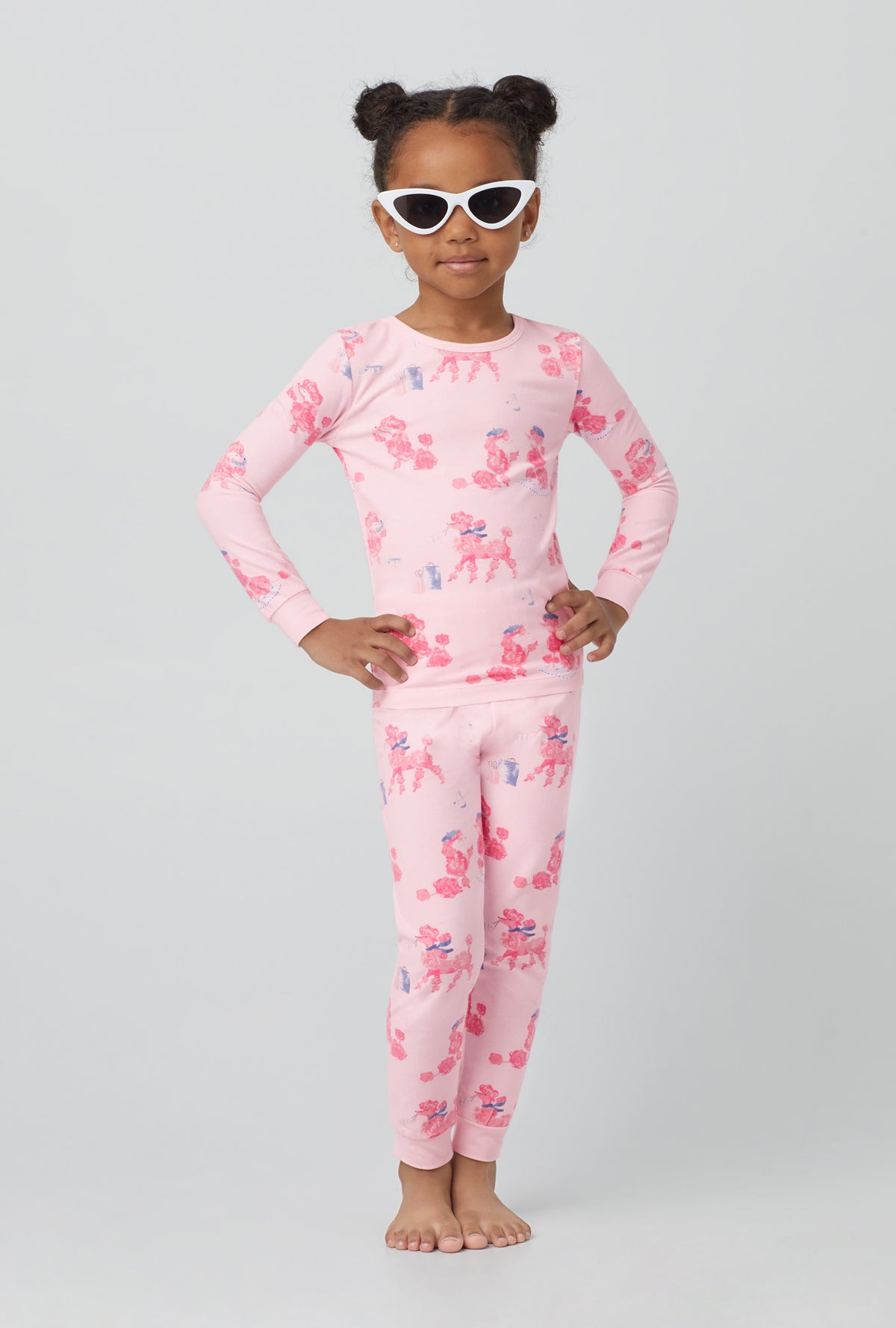 A girl wearing  Long Sleeve Stretch Jersey Kids PJ Set with pampered Poodles print