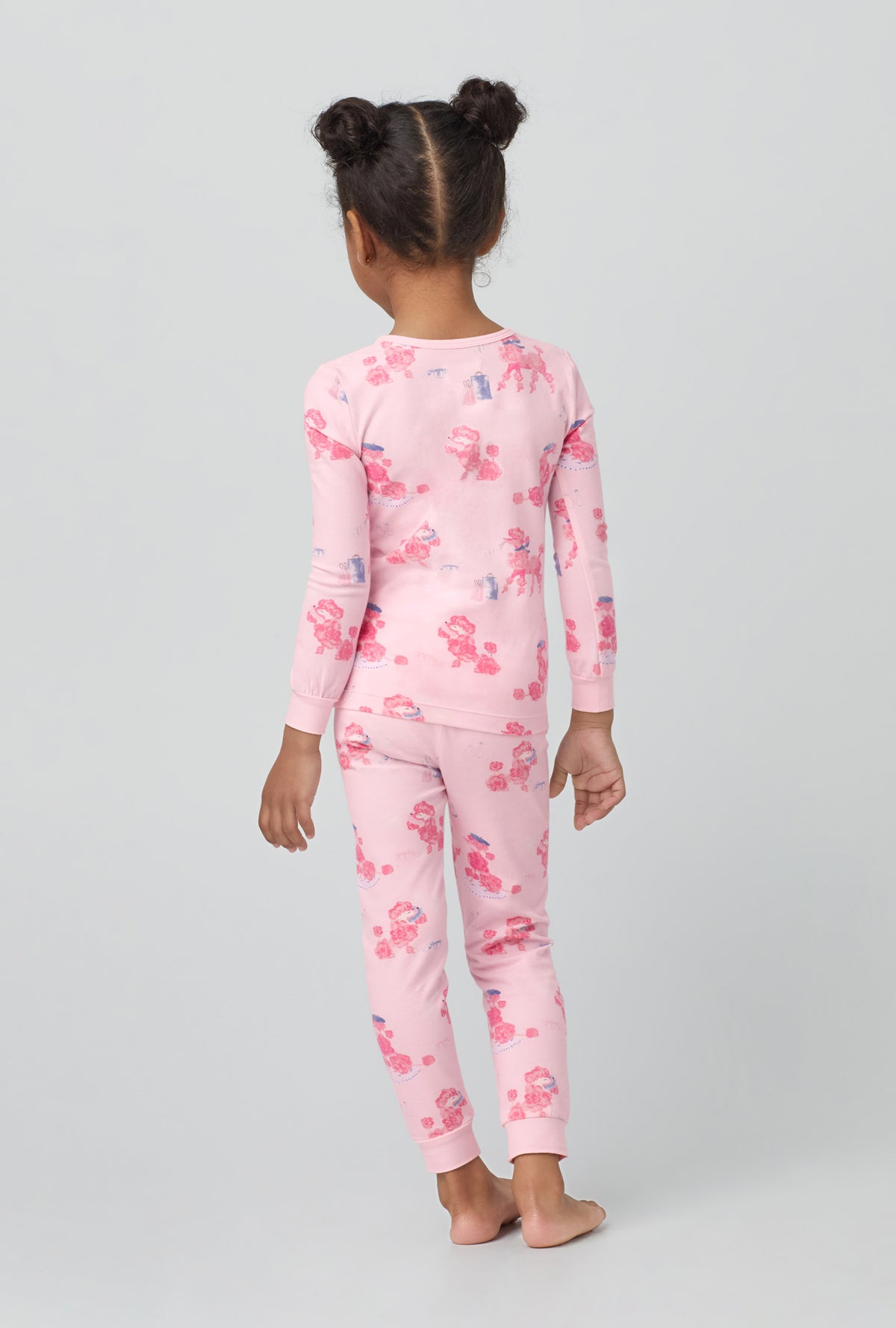 A girl wearing  Long Sleeve Stretch Jersey Kids PJ Set with pampered Poodles print