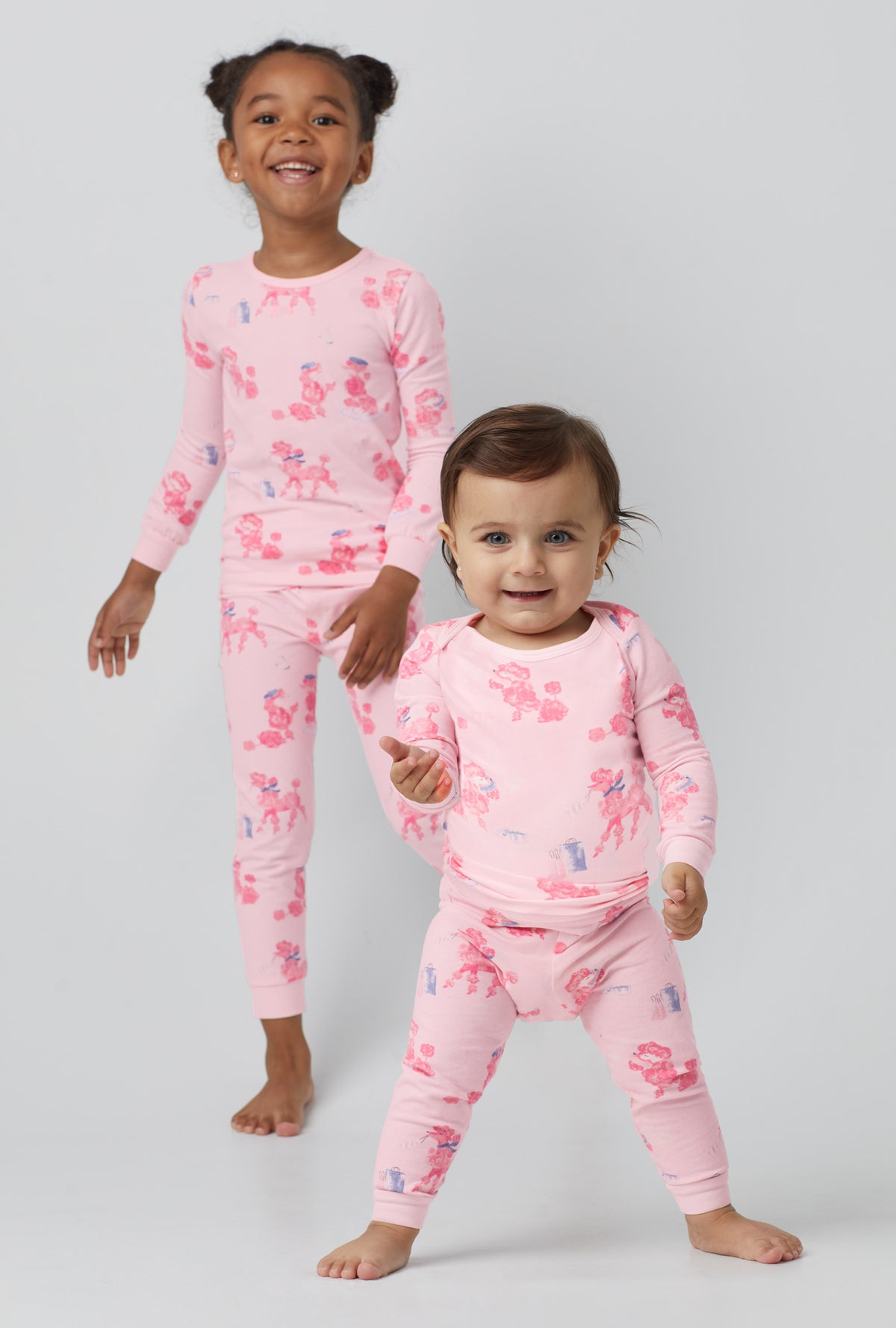 A girl wearing  Long Sleeve Stretch Jersey Kids PJ Set with pampered Poodles print