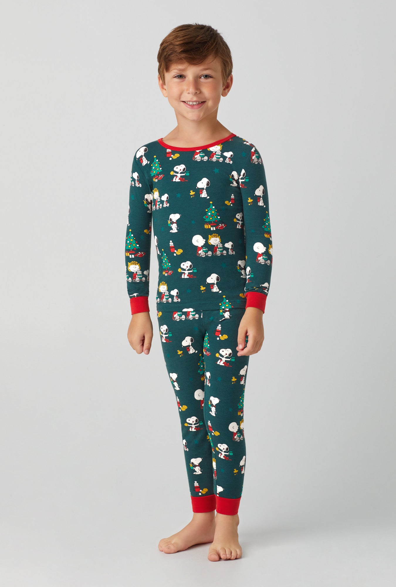 A kids wearing Long Sleeve Stretch Jersey Kids PJ Set with Snoopy's Cocoa  print