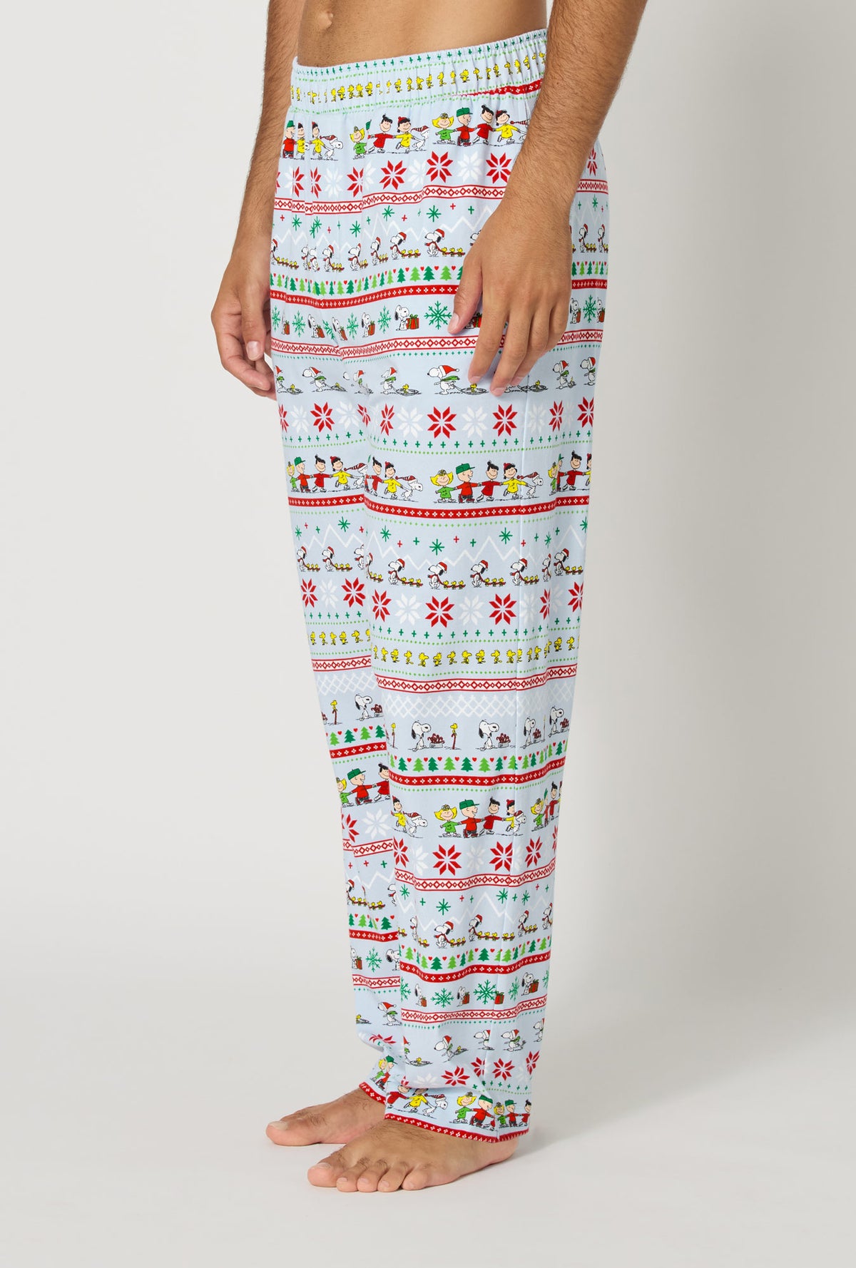 A Man wearing Peanuts® Winter Parade Men's Stretch Jersey Pj Pant side view