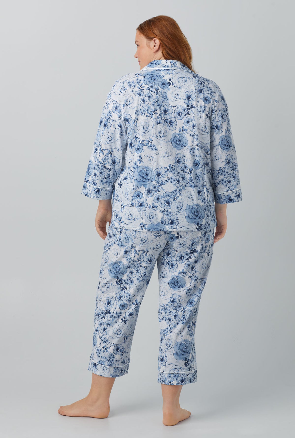 A lady wearing blue quarter sleeve classic stretch jersey cropped pj set with eternal blooms print.