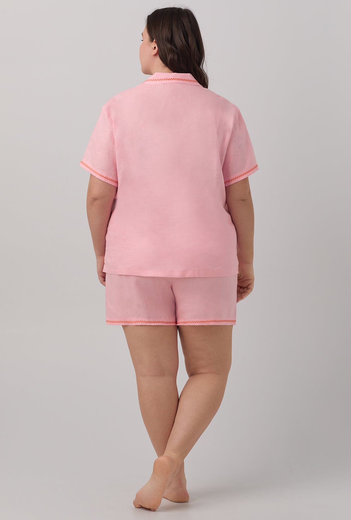 A lady wearing  plus size pink Short Sleeve Classic Shorty Woven Linen PJ Set with Orchid Pink print.