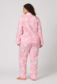 A Lady Wearing Plus Size Dynasty Pink Long Sleeve Classic Woven Cotton Poplin Pj Set in a back view pose