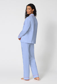 A Lady Wearing French Stripe Long Sleeve Classic Woven Supersoft Cotton Poplin Pj Set in a back view pose while looking back over the shoulder