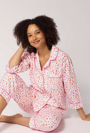 A lady wearing Blushwood 3/4 Sleeve Classic Woven Portuguese Flannel Cropped Pj Set sitting down
