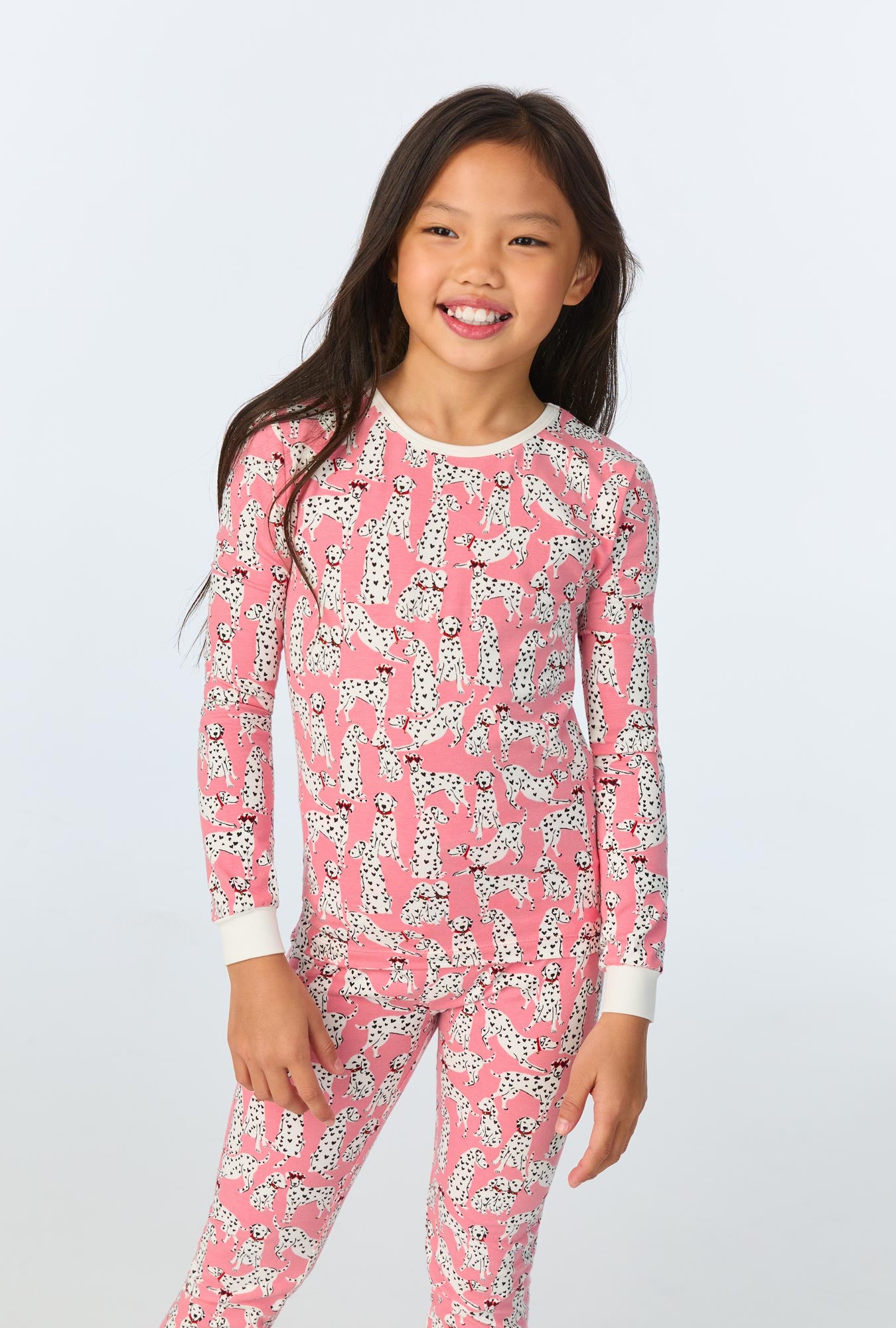 A girl wearing Love Spot Long Sleeve Stretch Jersey Kids PJ Set