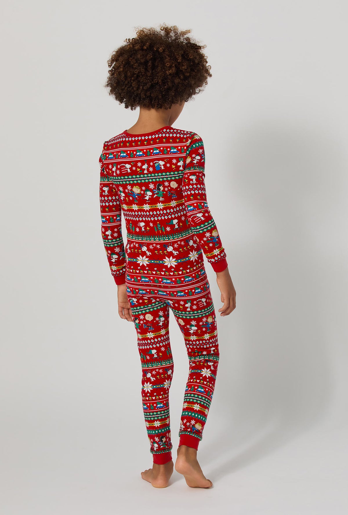 A girl wearing Peanuts®  Winter Fairisle Long Sleeve Stretch Jersey Kids Pj Set