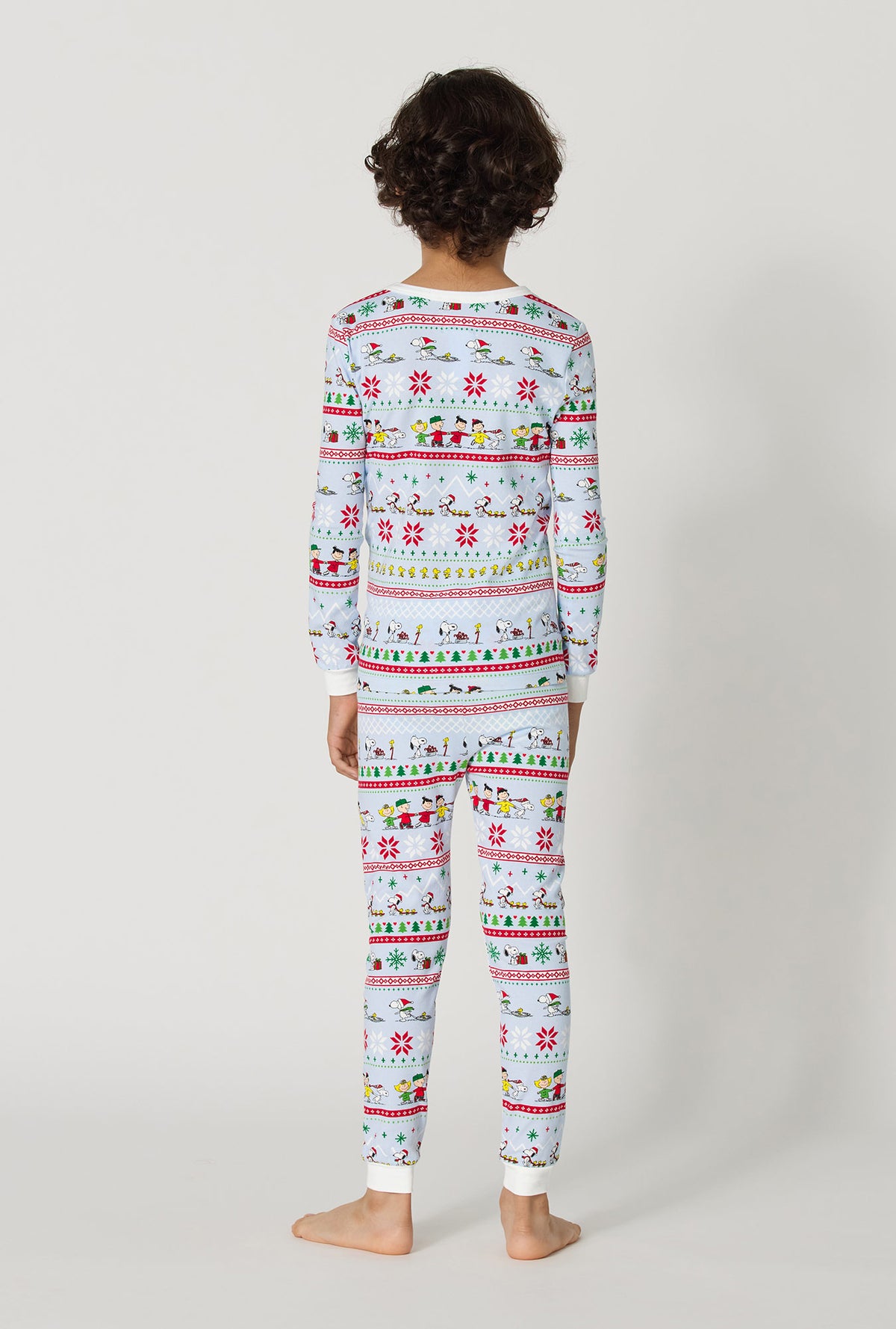 A boy wearing Peanuts® Winter Parade Long Sleeve Stretch Jersey Kids Pj Set back view