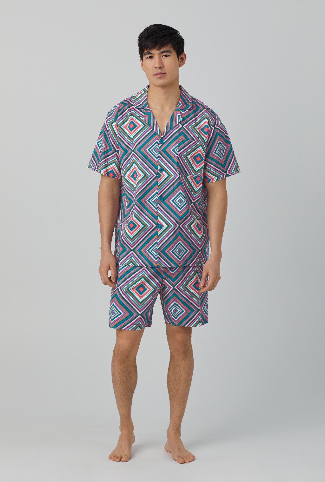A man wearing Short Sleeve Notch Woven Cotton Poplin Boxer PJ Set with diamond geo print