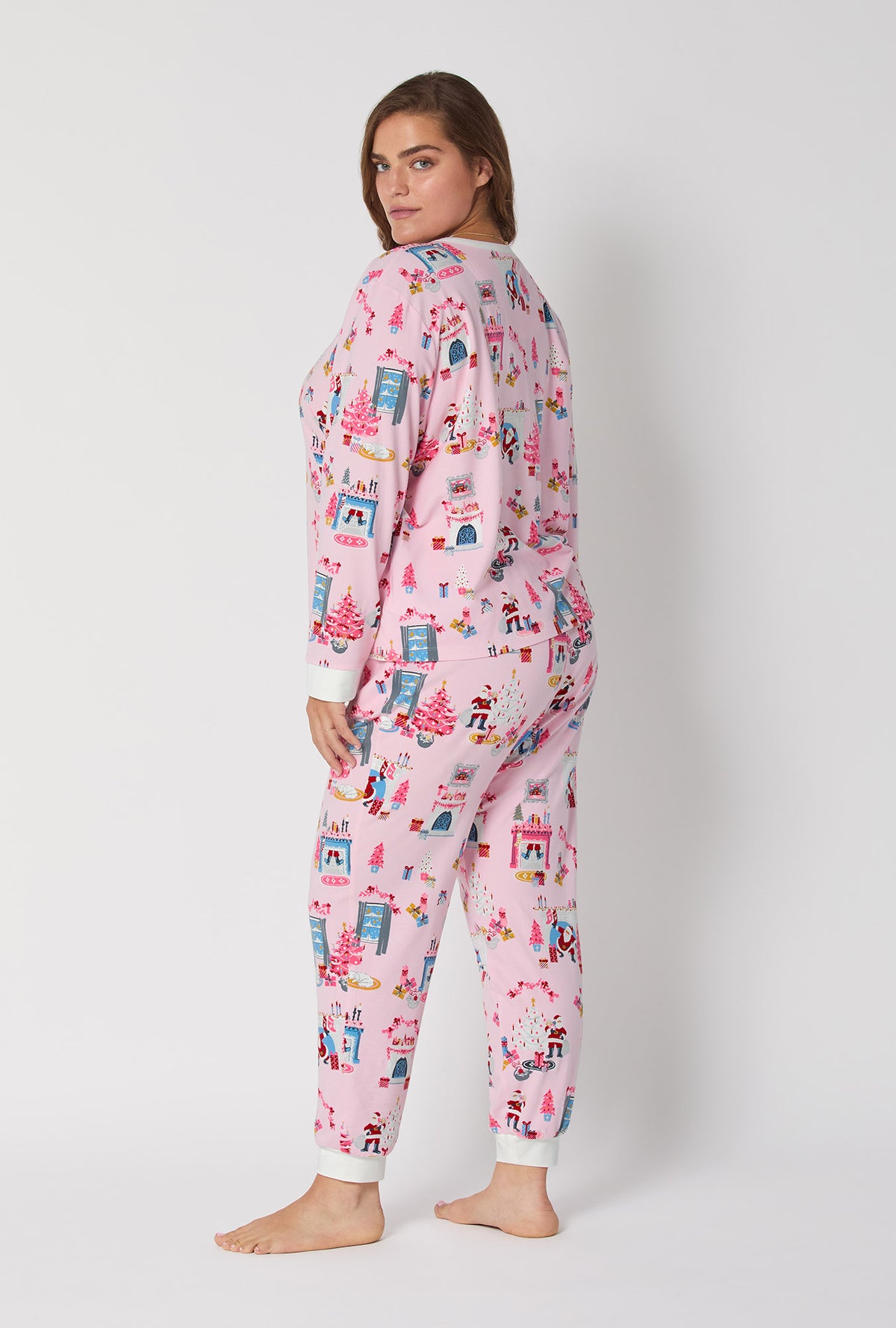 A lady wearing Must Be Santa Long Sleeve Pullover Crew And Jogger Stretch Jersey Pj Set
