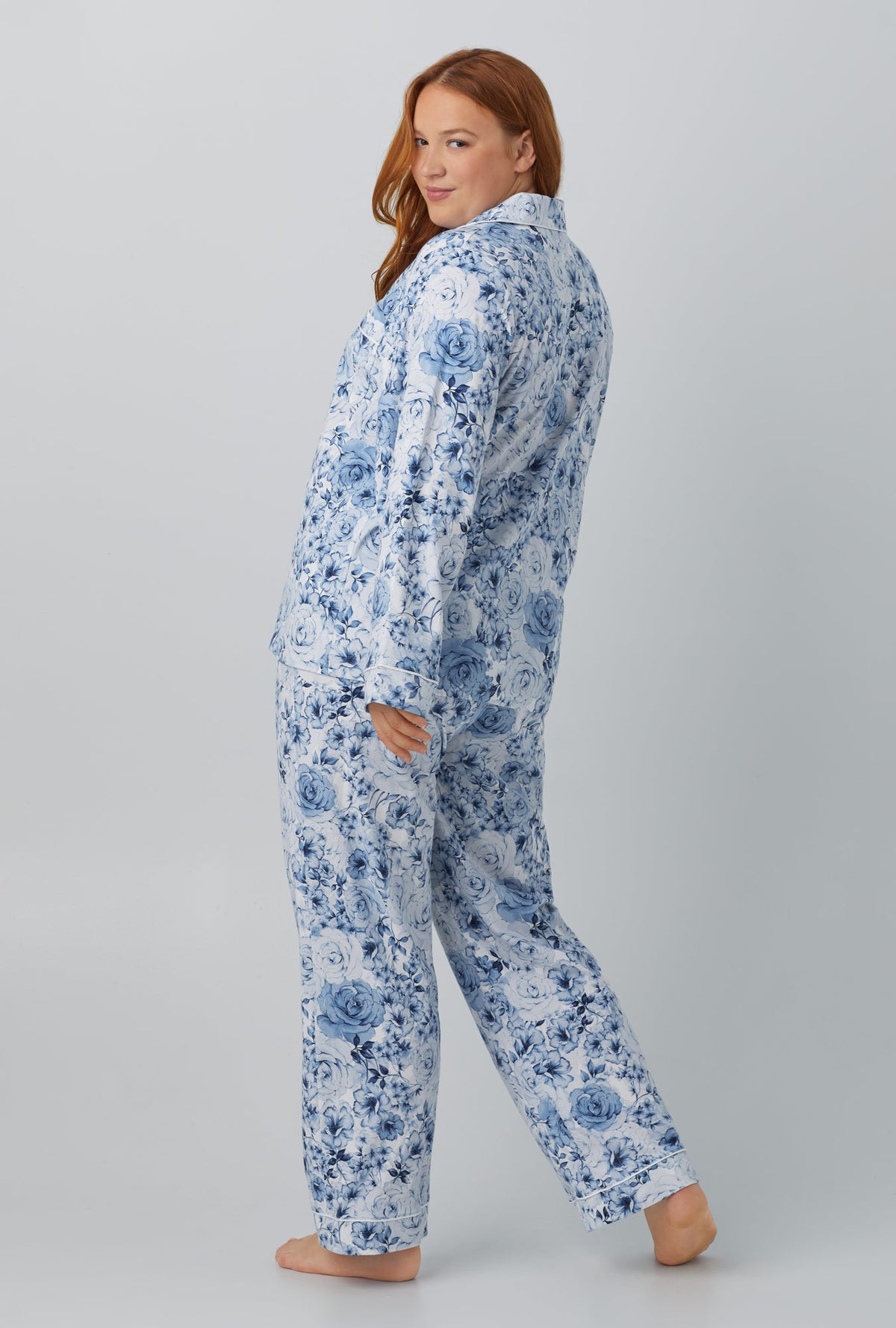 A lady wearing blue long sleeve classic stretch jersey cropped pj set with eternal blooms print.