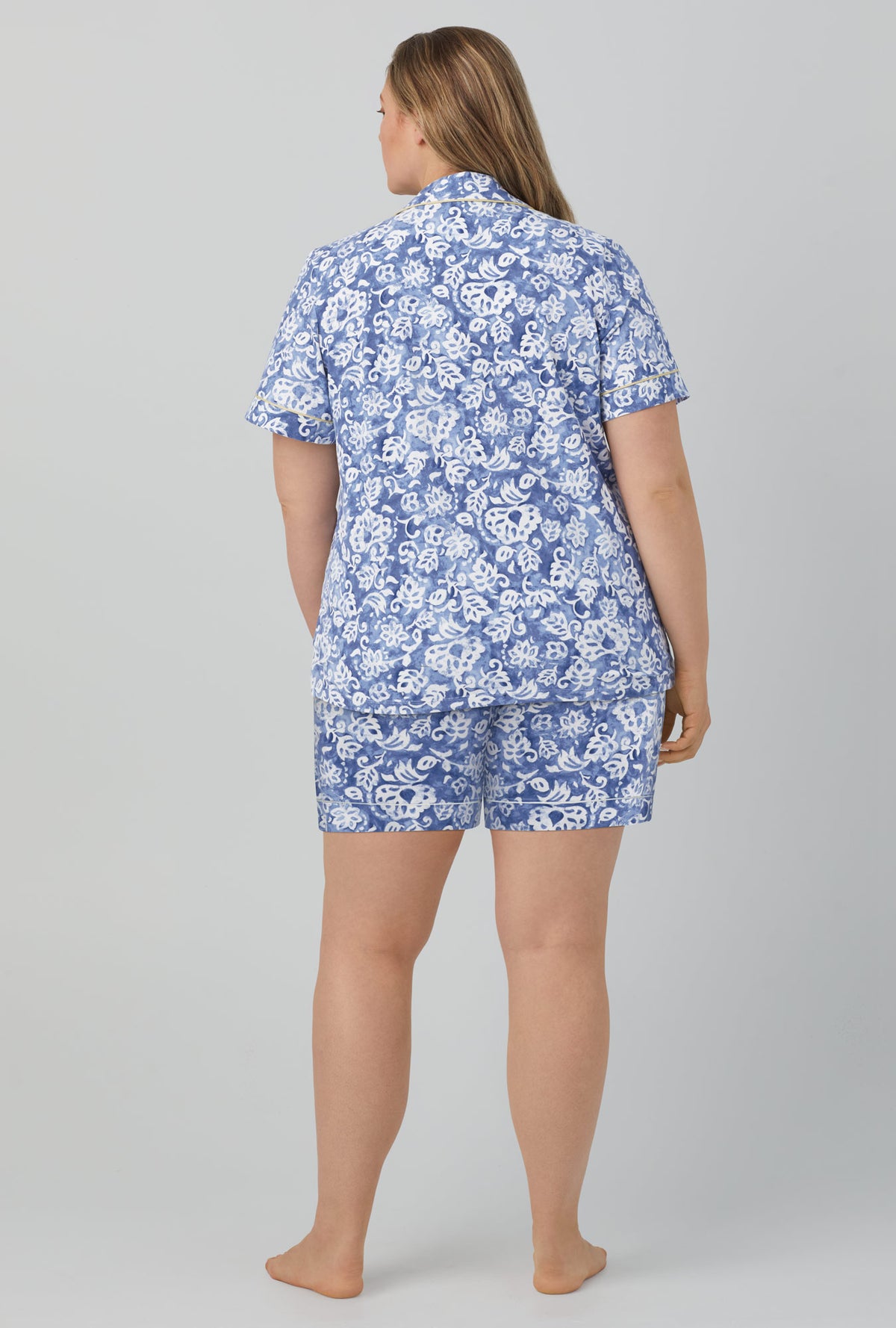 A lady wearing blue short sleeve classic short set stretch jersey pj set with autumn eve print