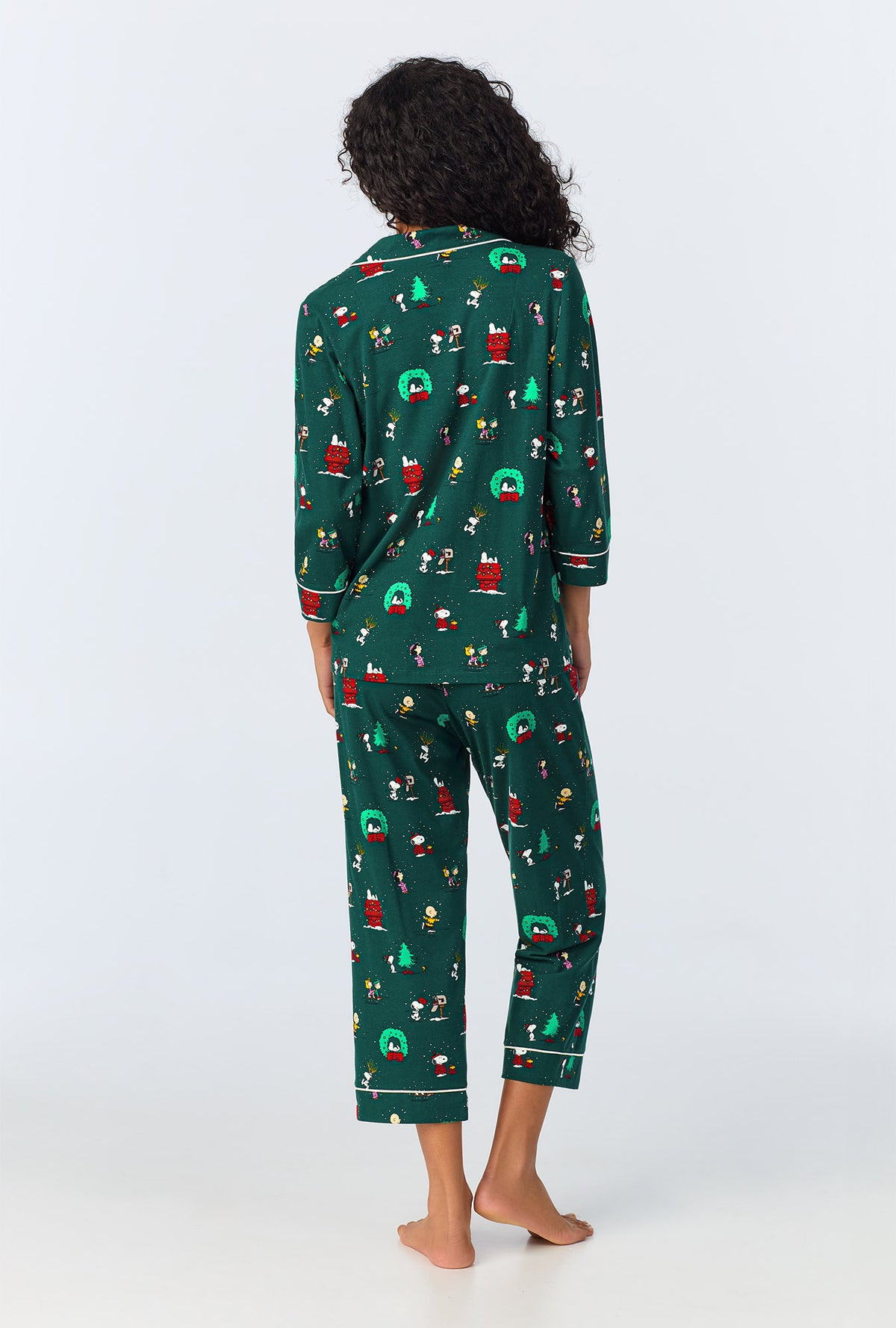 A lady wearing Peanuts® Winter Holiday 3/4 Sleeve Classic Stretch Jersey Cropped PJ Set