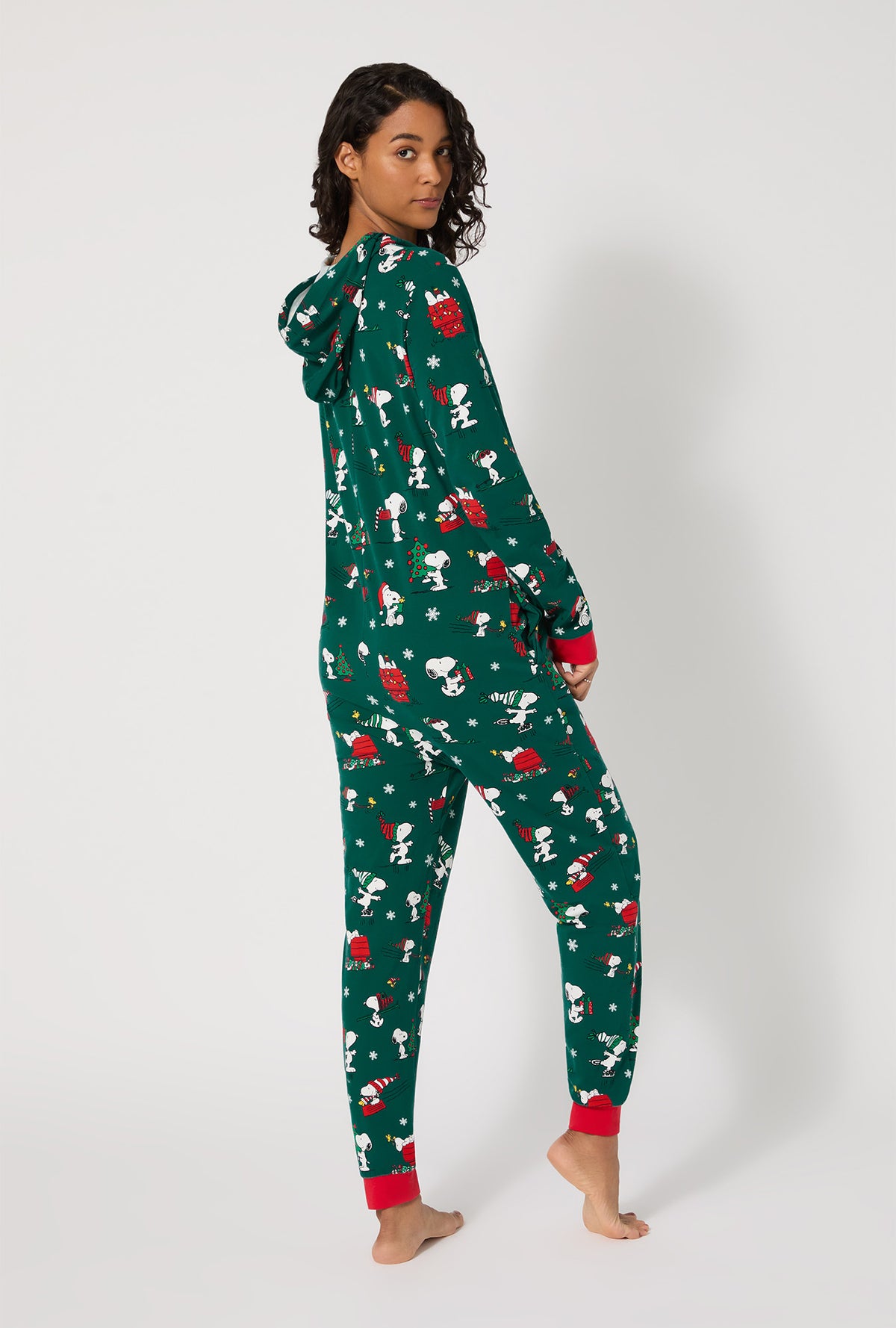 A lady wearing ®Snoopy's Holiday Fun Long Sleeve Stretch Jersey Unisex Onesie