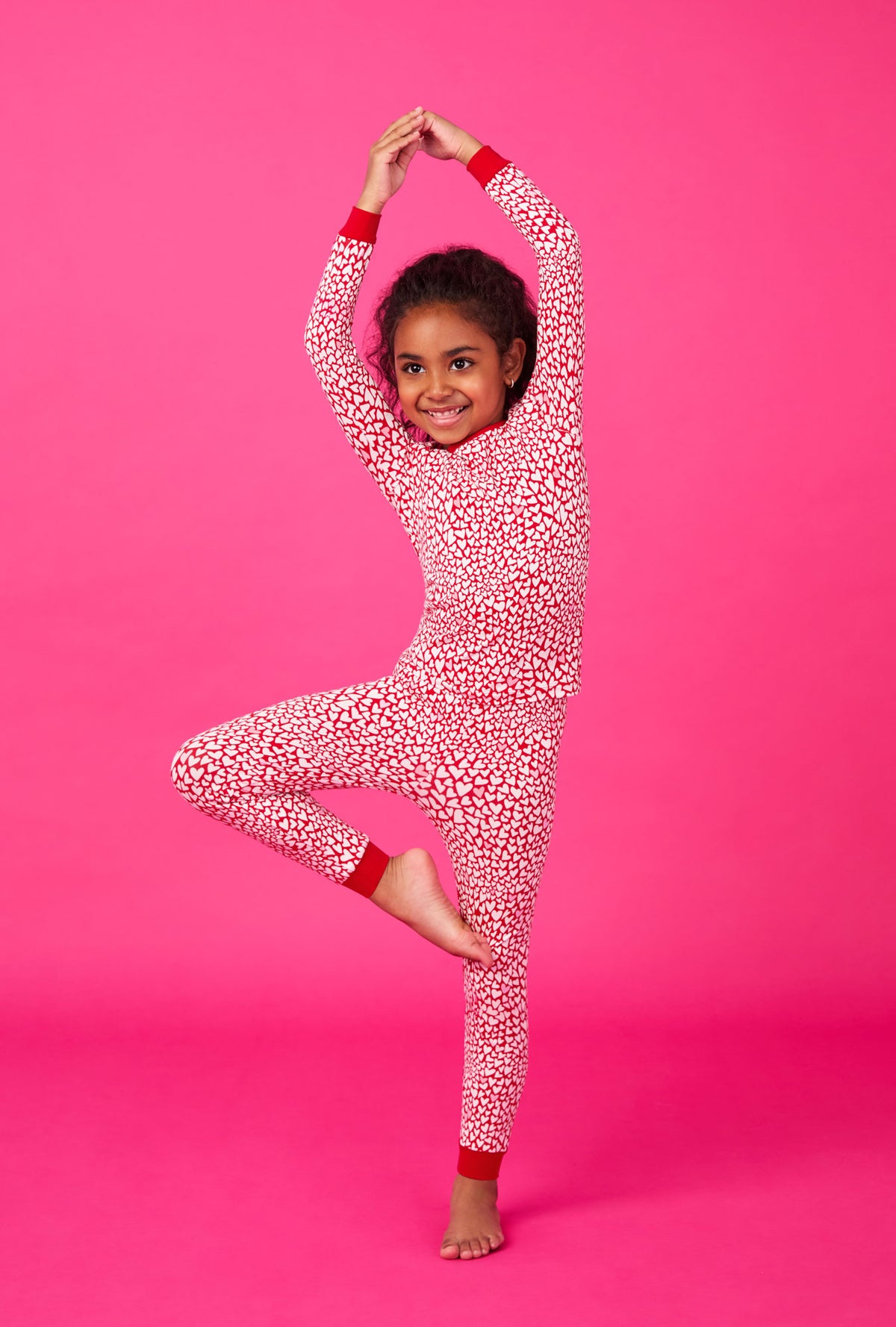 A girl wearing Bursting With Love Long Sleeve Stretch Jersey Kids Pj Set
