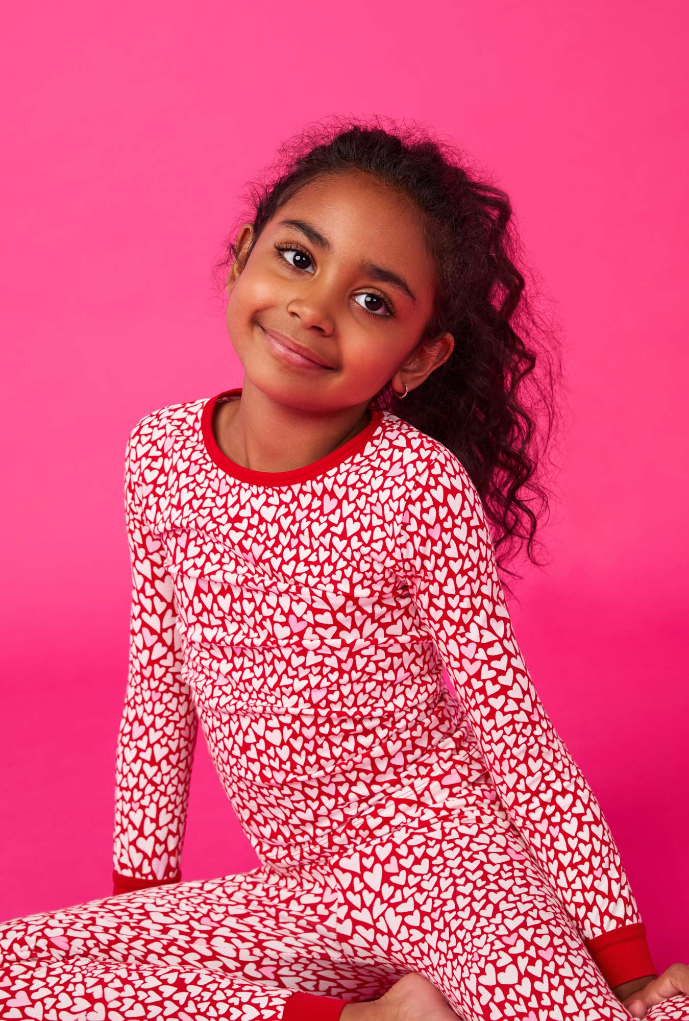 A girl wearing Bursting With Love Long Sleeve Stretch Jersey Kids Pj Set