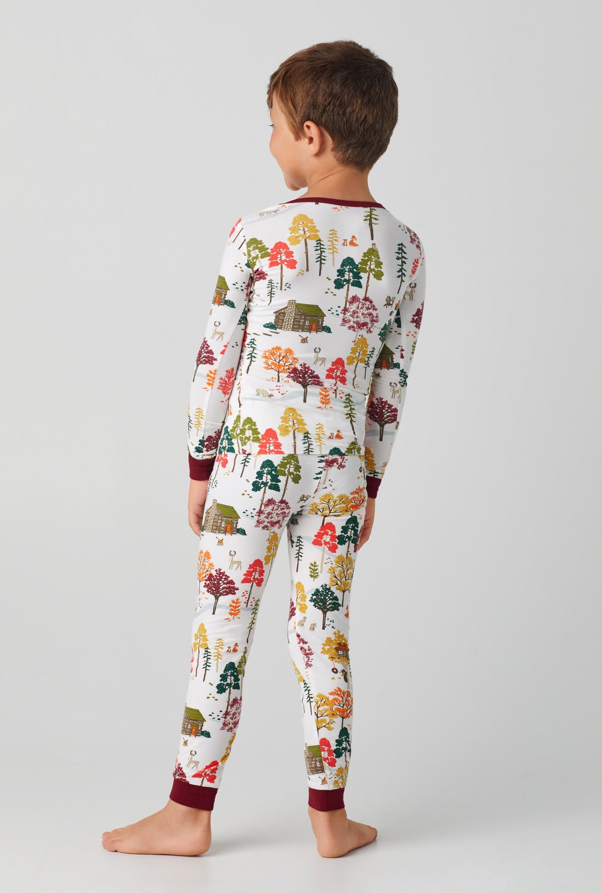 A boy wearing Long Sleeve Stretch Jersey PJ Set with forest retreat print