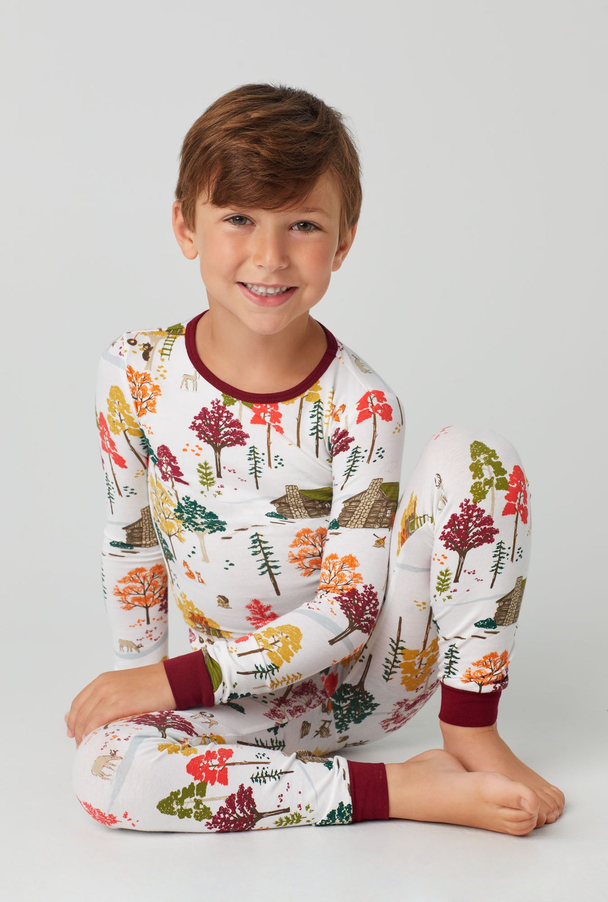 A boy wearing Long Sleeve Stretch Jersey PJ Set with forest retreat print
