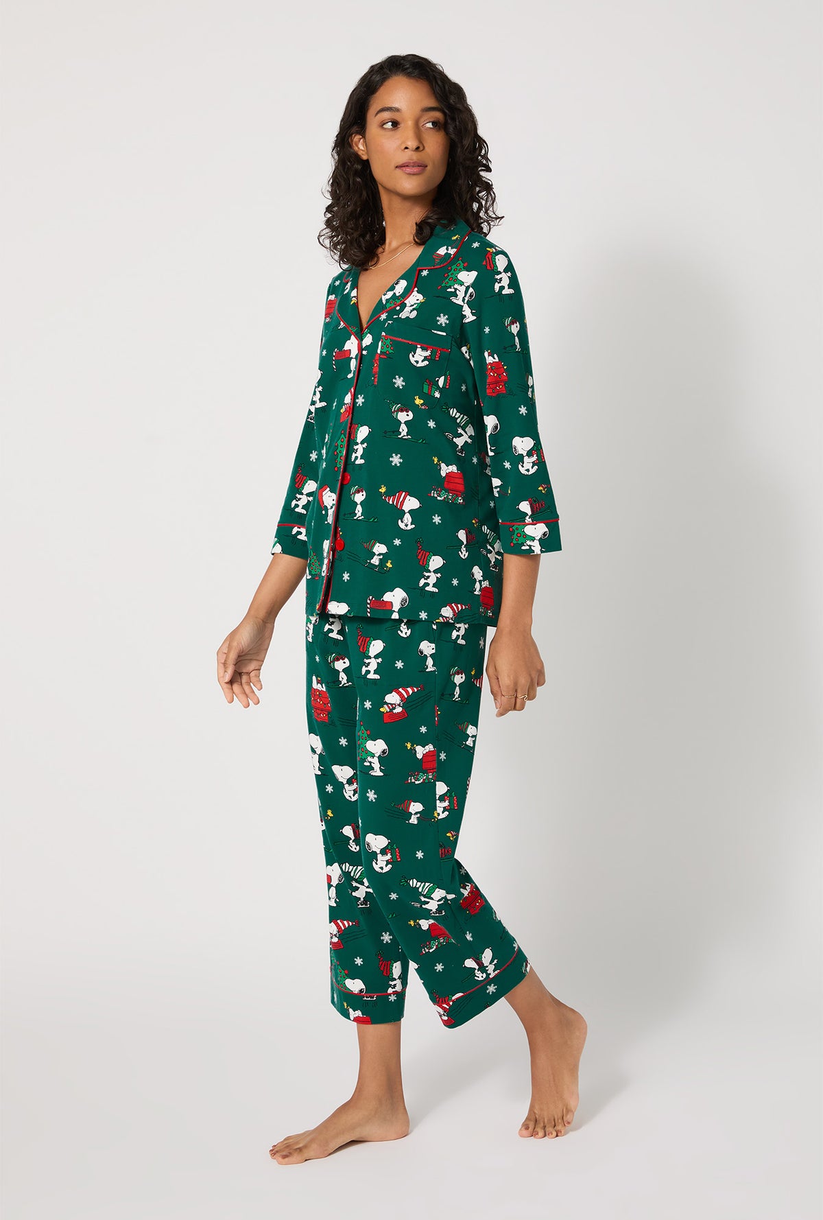 A lady wearing ®Snoopy's Holiday Fun 3/4 Sleeve Classic Stretch Jersey Cropped Pj Set