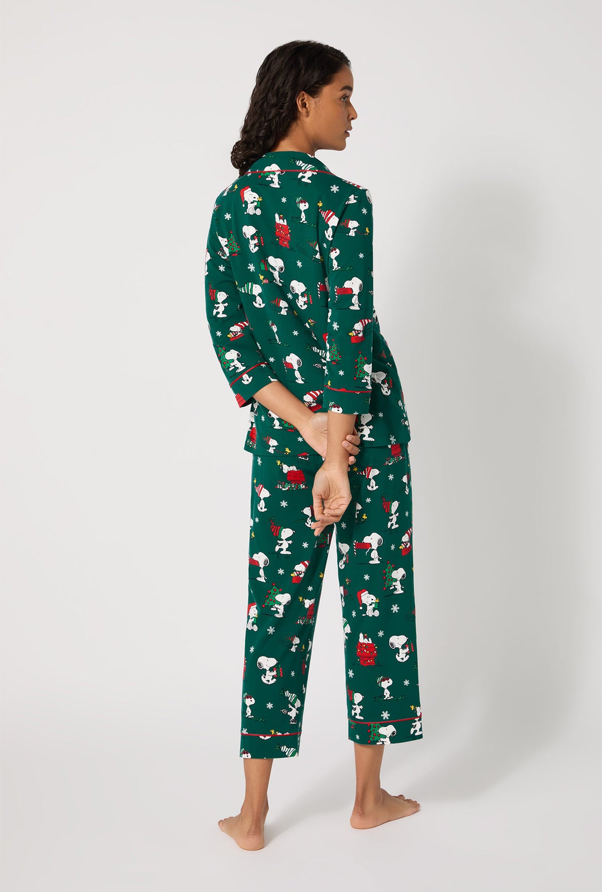 A lady wearing ®Snoopy's Holiday Fun 3/4 Sleeve Classic Stretch Jersey Cropped Pj Set
