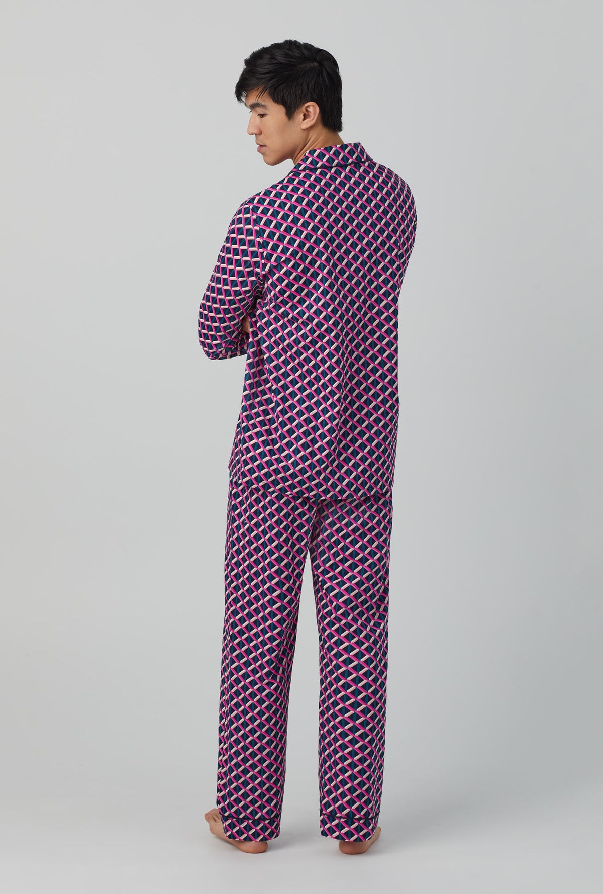 A man wearing long sleeve classic woven cotton poplin pj set with Mr. turk lattice geo print.