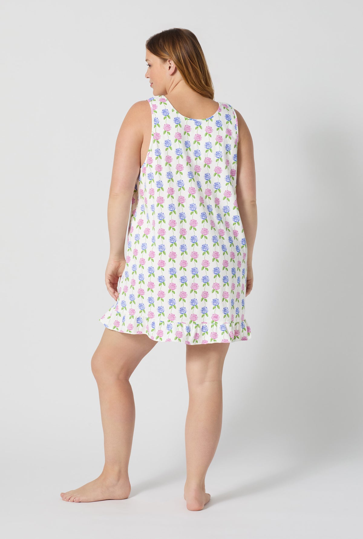 A lady wearing plus size Cottage Parlor Ruffle Stretch Jersey Chemise back view