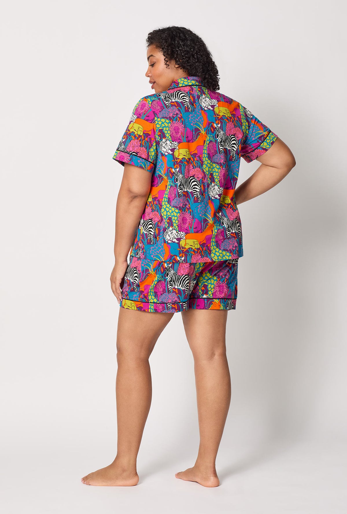 A lady wearing plus size BedHead x Trina Turk Jungle Short Sleeve Classic Shorty Stretch Jersey Pj Set