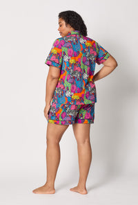 A lady wearing plus size BedHead x Trina Turk Jungle Short Sleeve Classic Shorty Stretch Jersey Pj Set